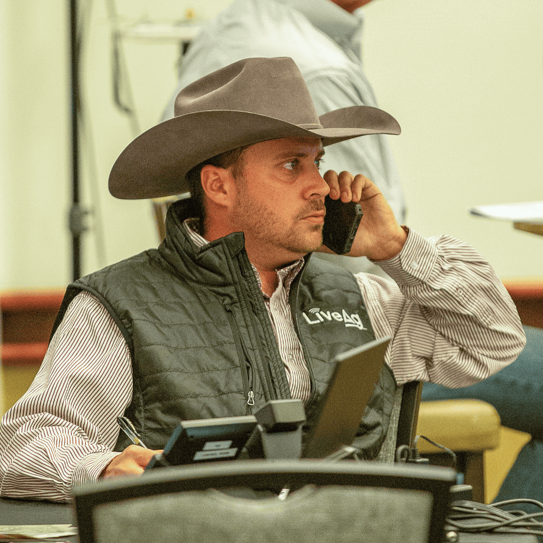 LiveAg Rep talking to customer on phone from live auction event.